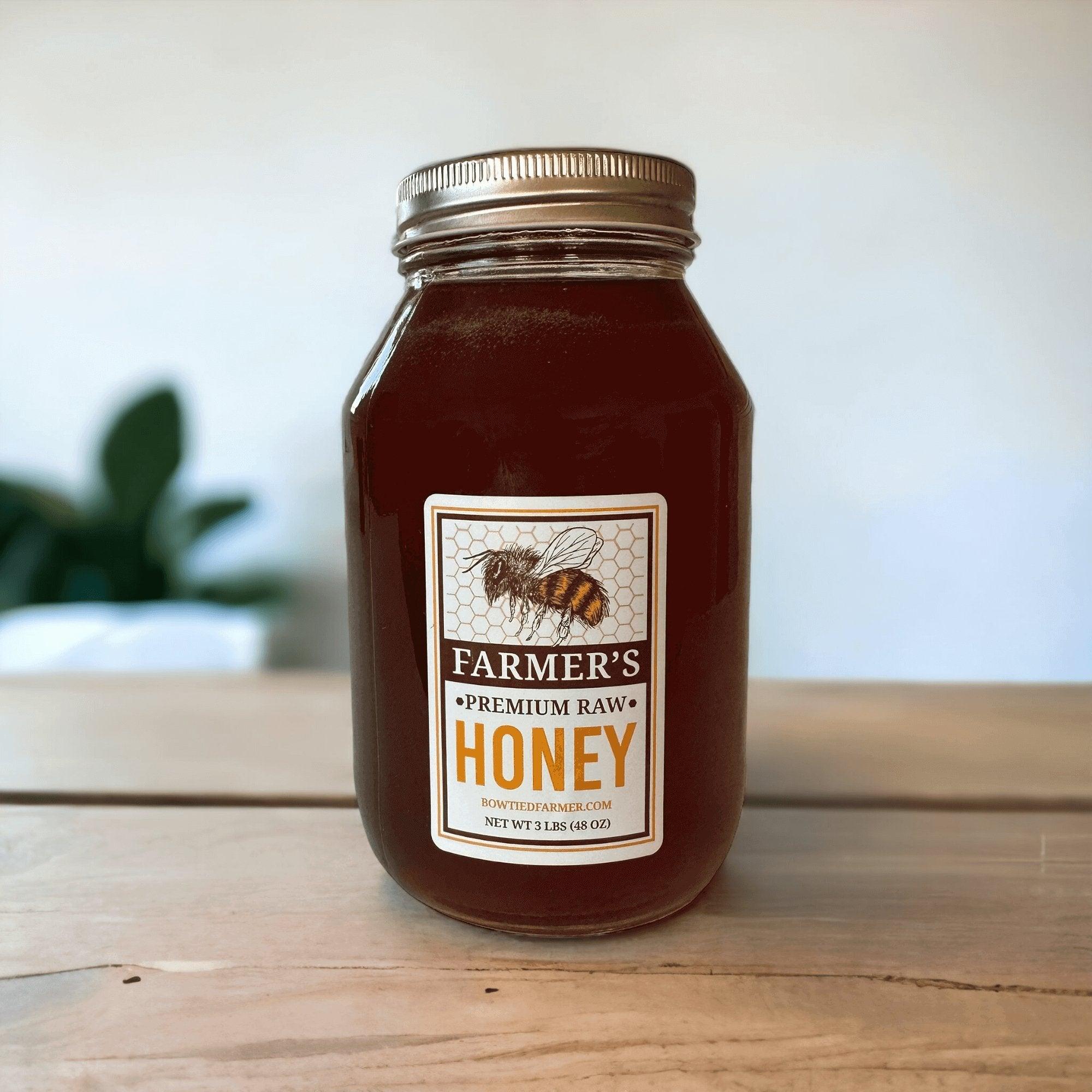 Farmer's Premium Raw Honey - Quart Glass Jar (3 LBS) on a table